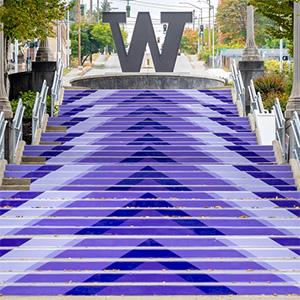Large purple arrow graphics on Grand Staircase point up to the Steel W at UW Tacoma.