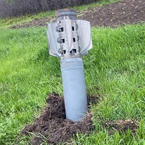 Unexploded rocket embedded in grass in Ukraine.