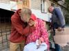 David Pavenko hugging older woman in Izium, Ukraine.