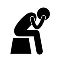 Person sitting with head in hands icon