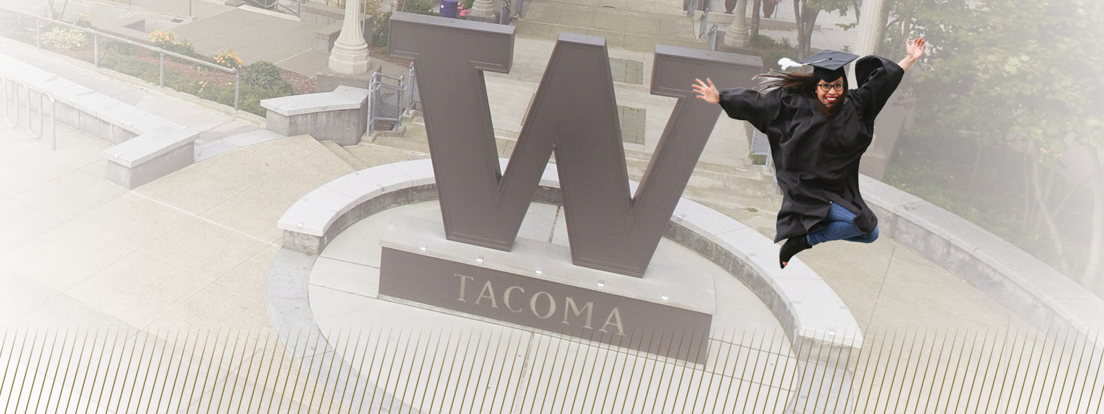 Photo illustration showing UW Tacoma grad flying through air before campus steel W.