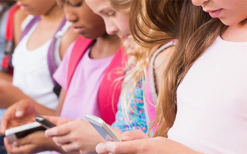School children using smart phones