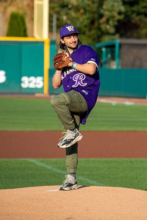 Eric Barone, '11, throwing the first pitch at Paint the Park Purple.
