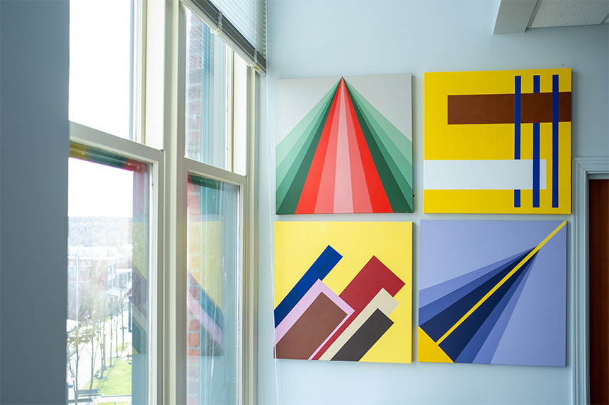 Four paintings by retired UW Tacoma faculty member JW Harrington are now hanging on the wall in Altaf Merchant's campus office.