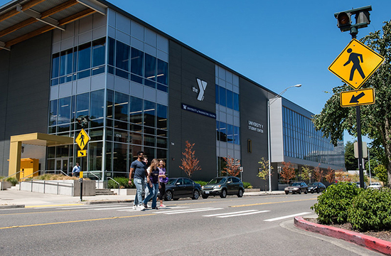 University Y Student center with students crossing the street