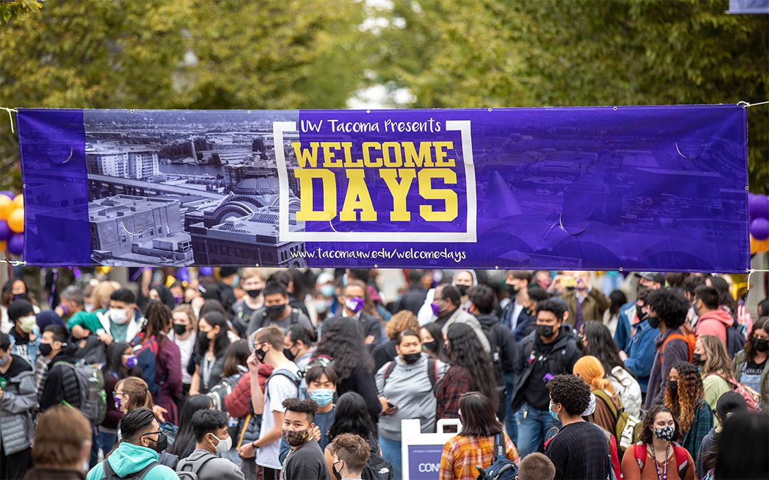 Banner reading "UW Tacoma Presents Welcome Days" with crowds of attendees below.
