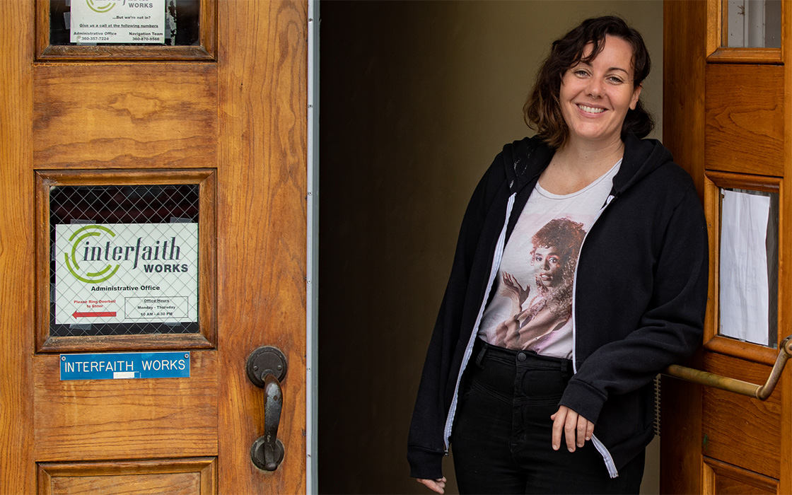 Meg Martin, '13 (MSW), standing in the entrance to Interfaith Works, the agency she directs in Olympia.