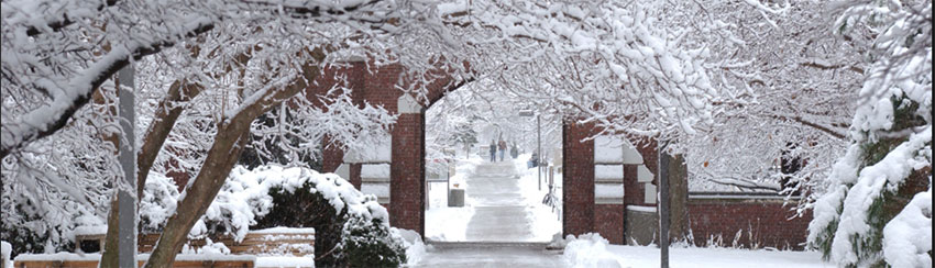 Brick entrance gate at Iowa State University, on a snowy day.