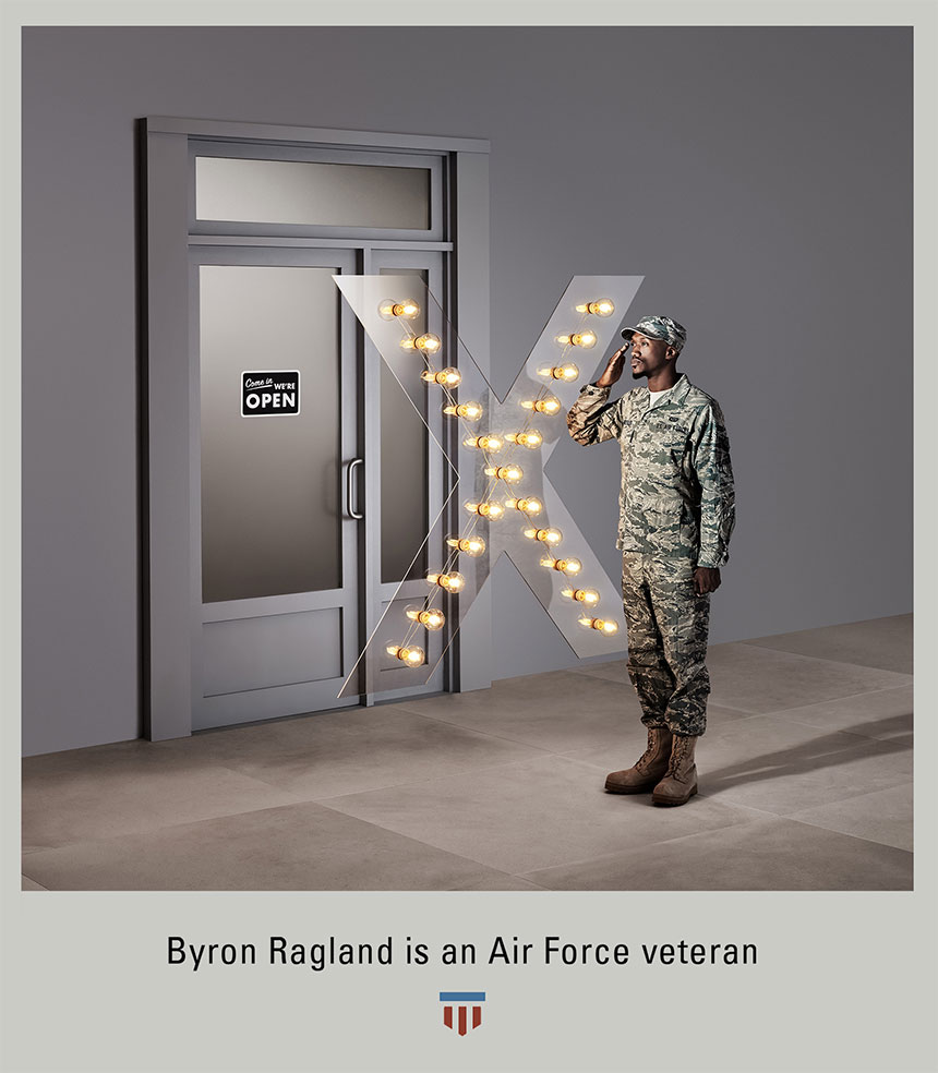 Byron Ragland, posed in U.S. Air Force uniform, saluting, with illuminated 'X' blocking access to door.