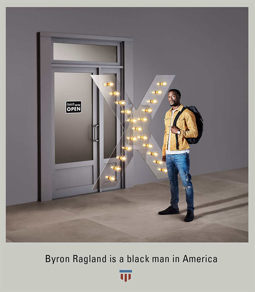 Byron Ragland, posed in in casual clothes with backpack, with illuminated 'X' blocking access to door.