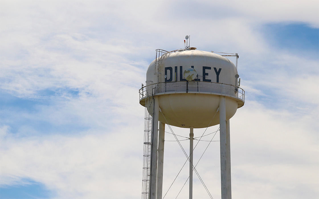 Water tower at Dilley, Tex., with clouds and blue sky in background