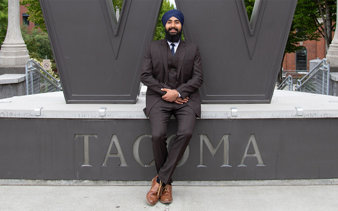 Portrait of Gurchetan Singh sitting under UW Tacoma steel W