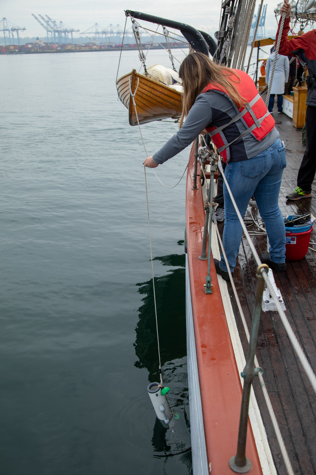 Dropping a Niskin bottle over the side of Adventuress into Commencement Bay