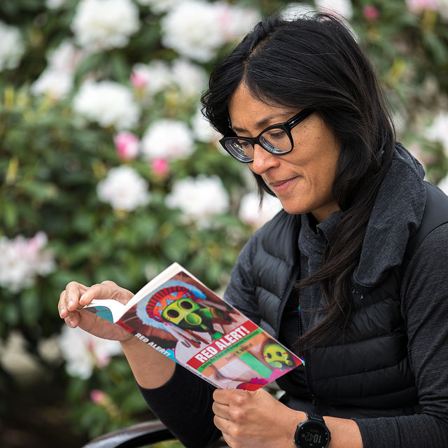 UW Tacoma Associate Professor Michelle Montgomery, reading book "Red Alert!"