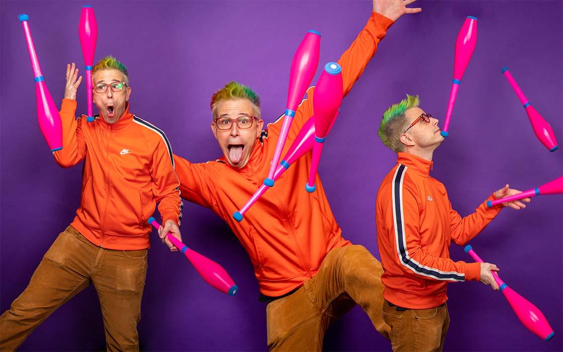 UW Tacoma senior Alex Zerbe in a series of photos showing him juggling pink clubs. He is wearing orange pants and an orange jacket. The backdrop is purple.