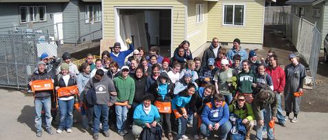 Group photo of college students building a house with Habitat for Humanity