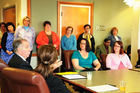 Group of UW Tacoma staff and faculty observing UW President Michael Young and UW Tacoma Chancellor Debra Friedman