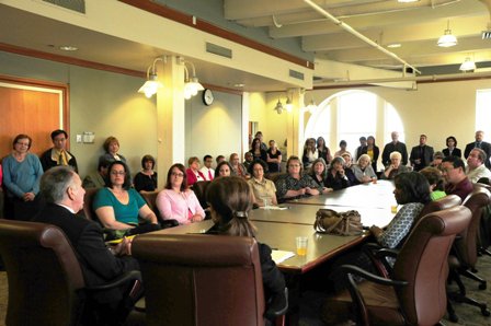 Crowd of faculty and staff in GWP conference room with UW President Michael Young and UW Tacoma Chancellor Debra Friedman