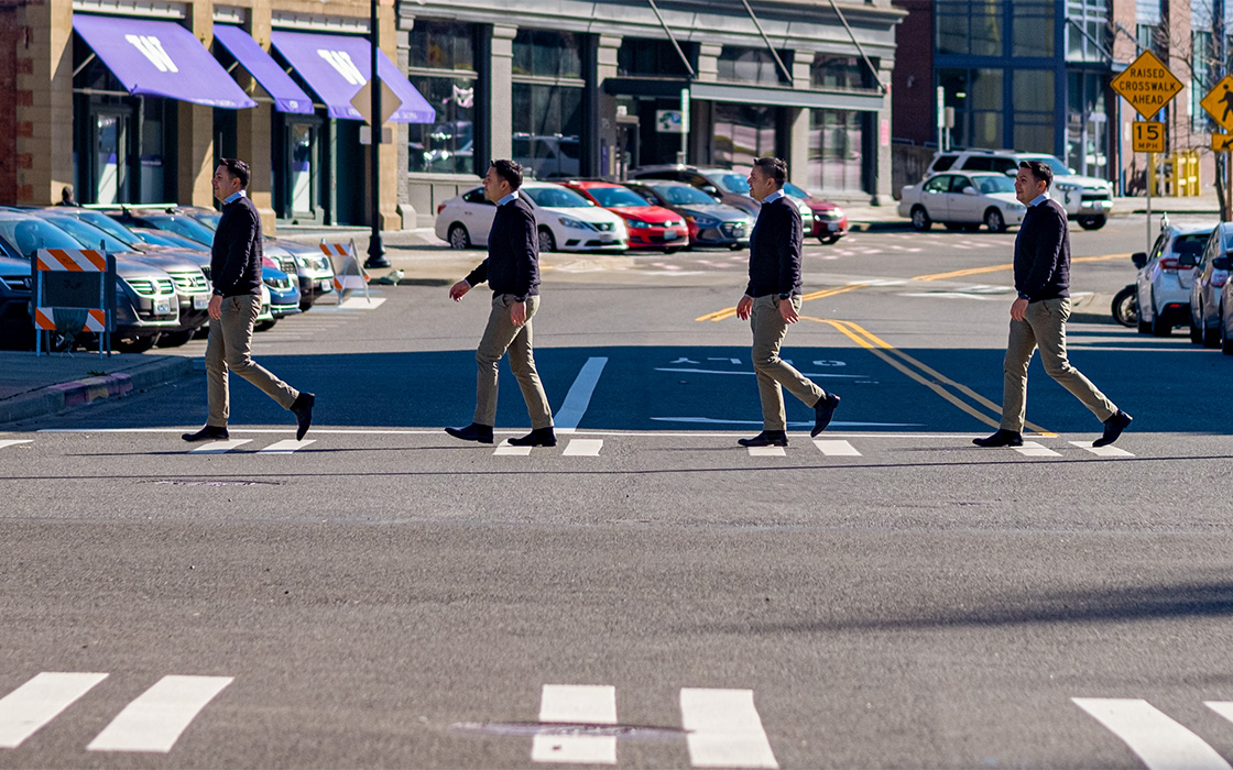 Photo illustration showing multiple images of Dr. Ruben Casas walking across a zebra crosswalk on UW Tacoma campus