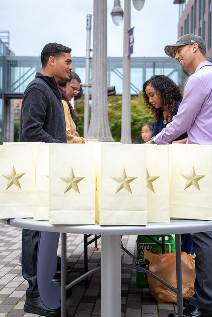 Student veterans on UW Tacoma's Prairie Line Trail assembling luminaries printed with gold stars