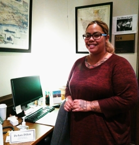 Intern standing behind a desk