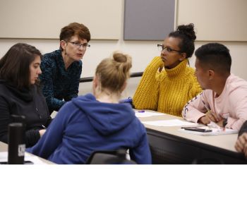 group of students discussing in a classroom