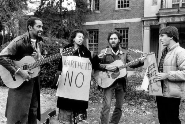 Mike Honey with guitar at center right, performing at a protest to end apartheid.