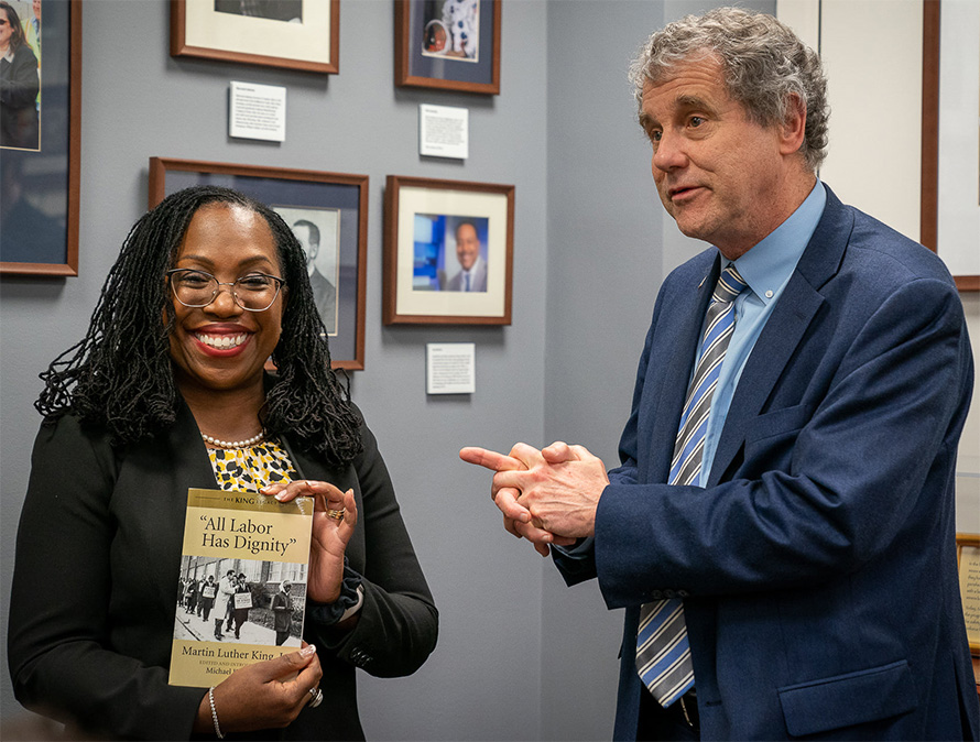 Then-Supreme Court nominee Ketanji Brown Jackson with U.S. Sen. Sherrod Brown, holding a copy of Mike Honey's edited volume of speeches by Martin Luther King, Jr.
