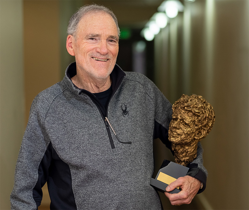 Mike Honey holding RFK Book Award bust of Robert F. Kennedy, Jr.