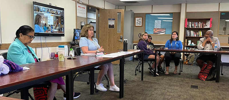 Inside the classroom at the Muckleshoot Tribal College. From left to right: Muckleshoot Council person Virginia Cross (far left), Dr. Denise Bill (next to her), daughters of Jessica Garcia-Jones, Muckleshoot Council person Jessica Garcia-Jones and Chancellor Sheila Edwards Lange