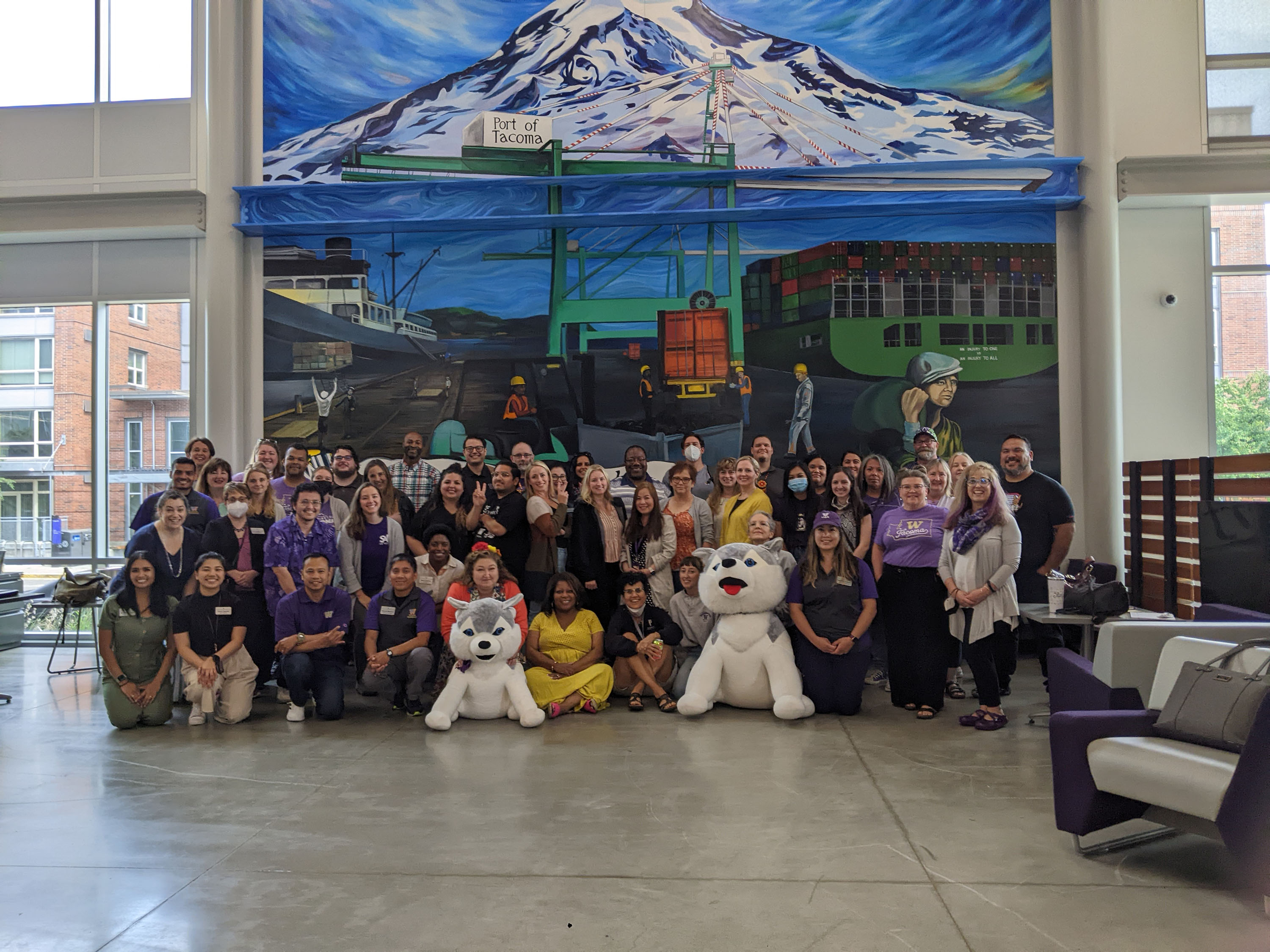 Photo of Student Affairs staff in front of Mt Rainier mural in University Y Student center