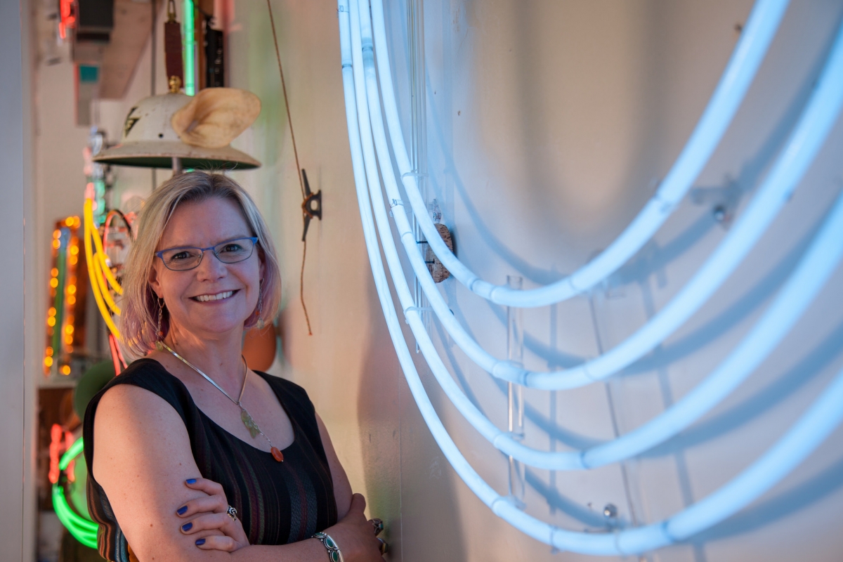 Amy McBride on receiving the 2017 UW Tacoma Distinguished Alumni Award: "I am humbled and honored. It's very rewarding to get to do what I do and be acknowledged for it." She stands in the window of the Woolworth Building, amidst Galen Turner's installation entitled NEON.