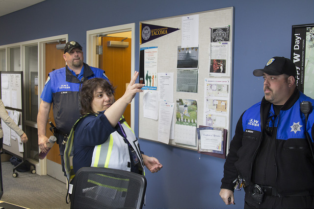 Susan Wagshul-Golden, director of UW Tacoma Campus Safety & Security, with two of her sergeants in a campus hallway.