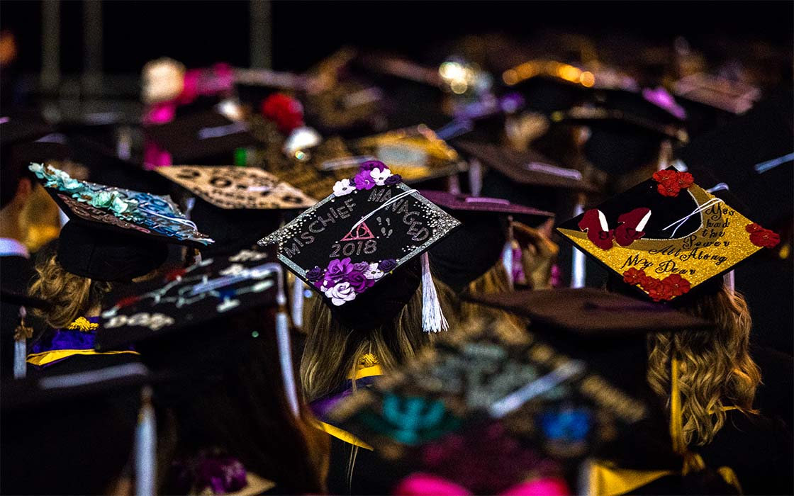 A plethora of colorful, customized tops of mortarboards at UW Tacoma 2018 Commencement