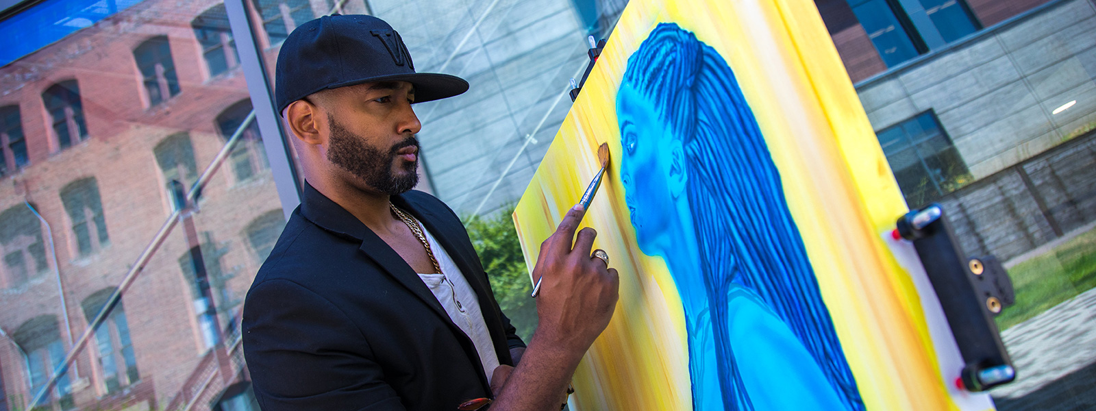 LeShawn Gamble, '19, B.A. Psychology, with one of his paintings.