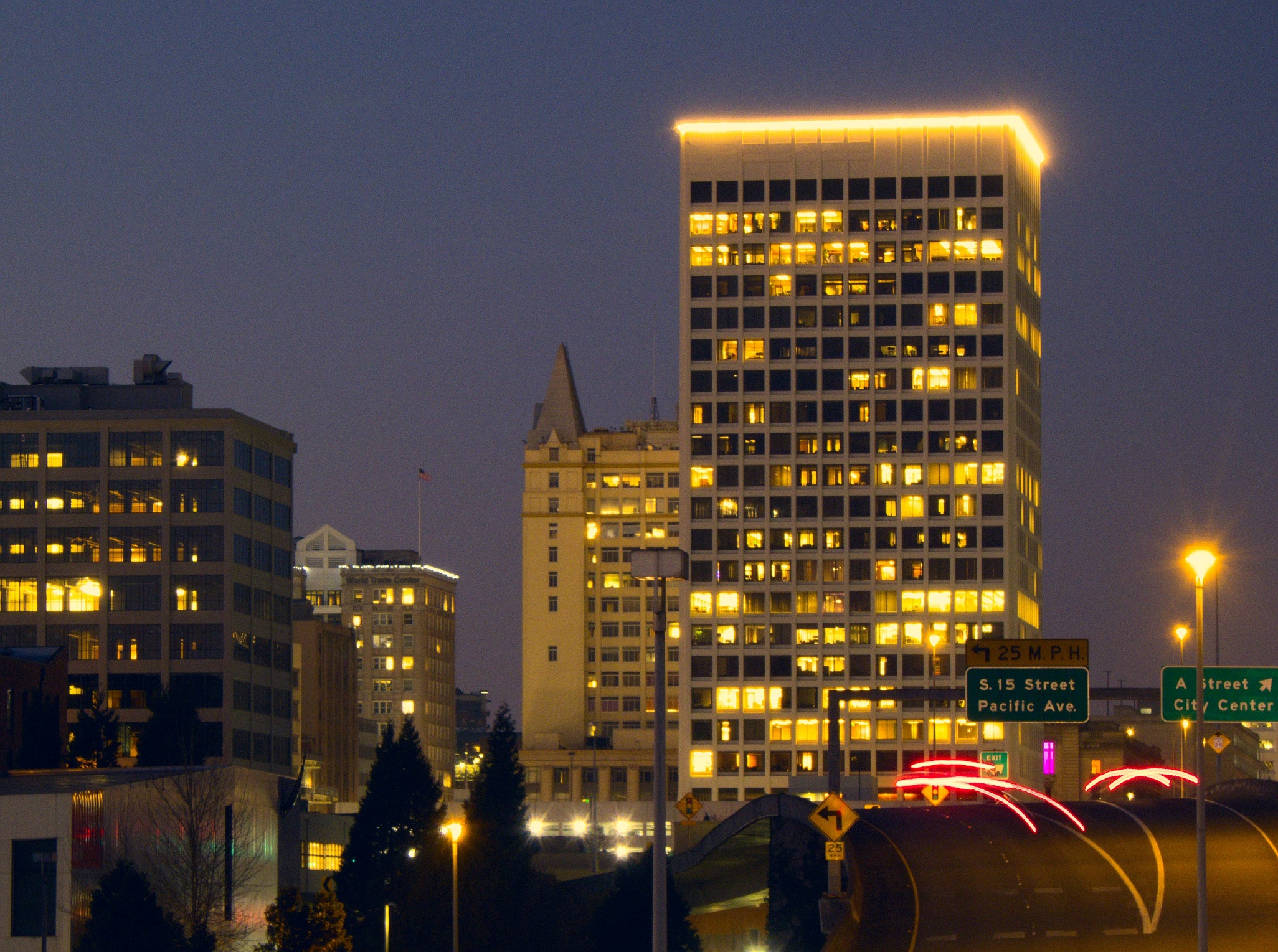 PICTURED: Buildings in downtown Tacoma at night from the perspective of I-705, which is in the foreground.