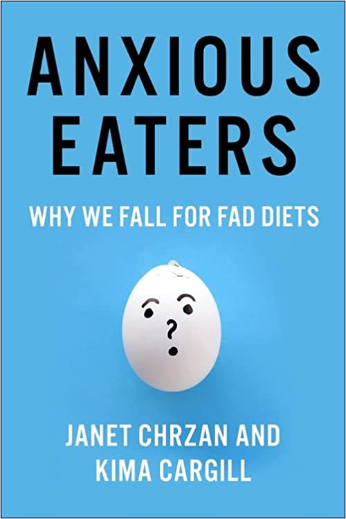 A copy of Kima Cargill's book "Anxious Eaters: Why We Fall for Fad Diets." The book is blue with black and white type. There is a picture of an egg with a face on it in the middle of the cover.
