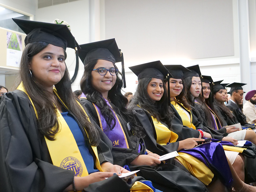 photo of students smiling in graduation attire