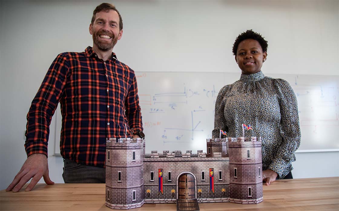 Jeff Walters and Angela Kitali with a cardboard castle.