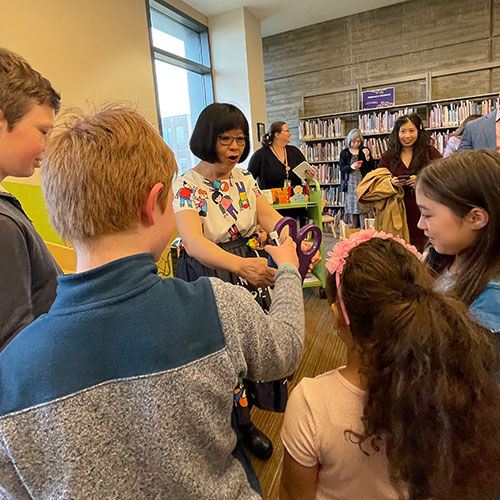 Belinda Louie (center) talks with children at the event