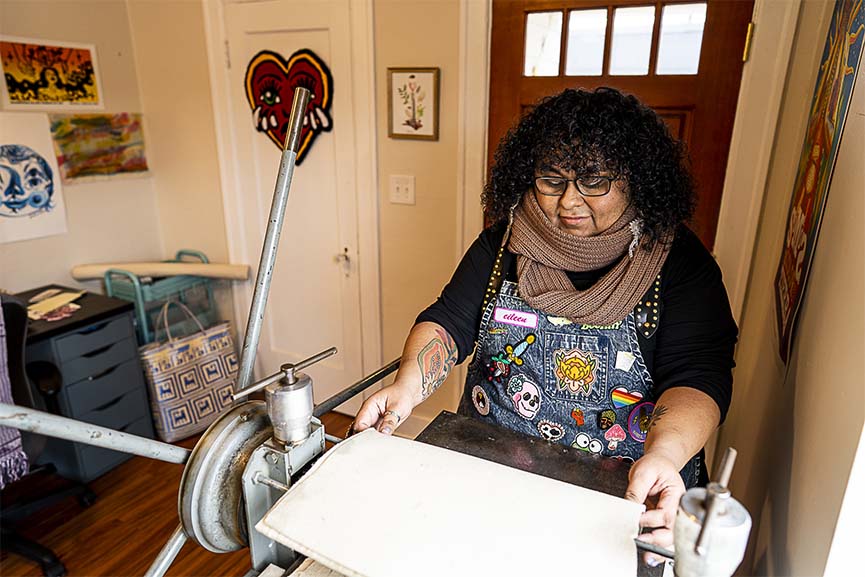 Eileen Jimenez making art at her press.