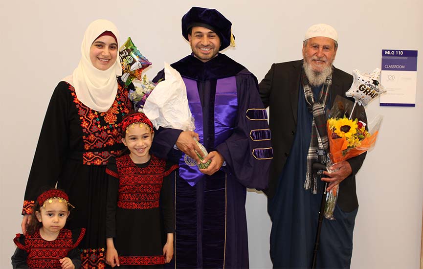 UW Tacoma Ph.D. candidate Abdulrahman Salama with wife, children and father at School of Engineering & Technology hooding ceremony in 2023.