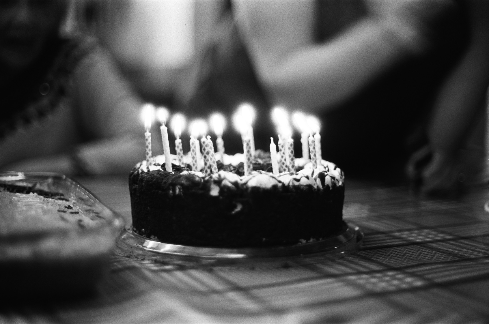 PICTURED: A black and white picture of a birthday cake and candles.
