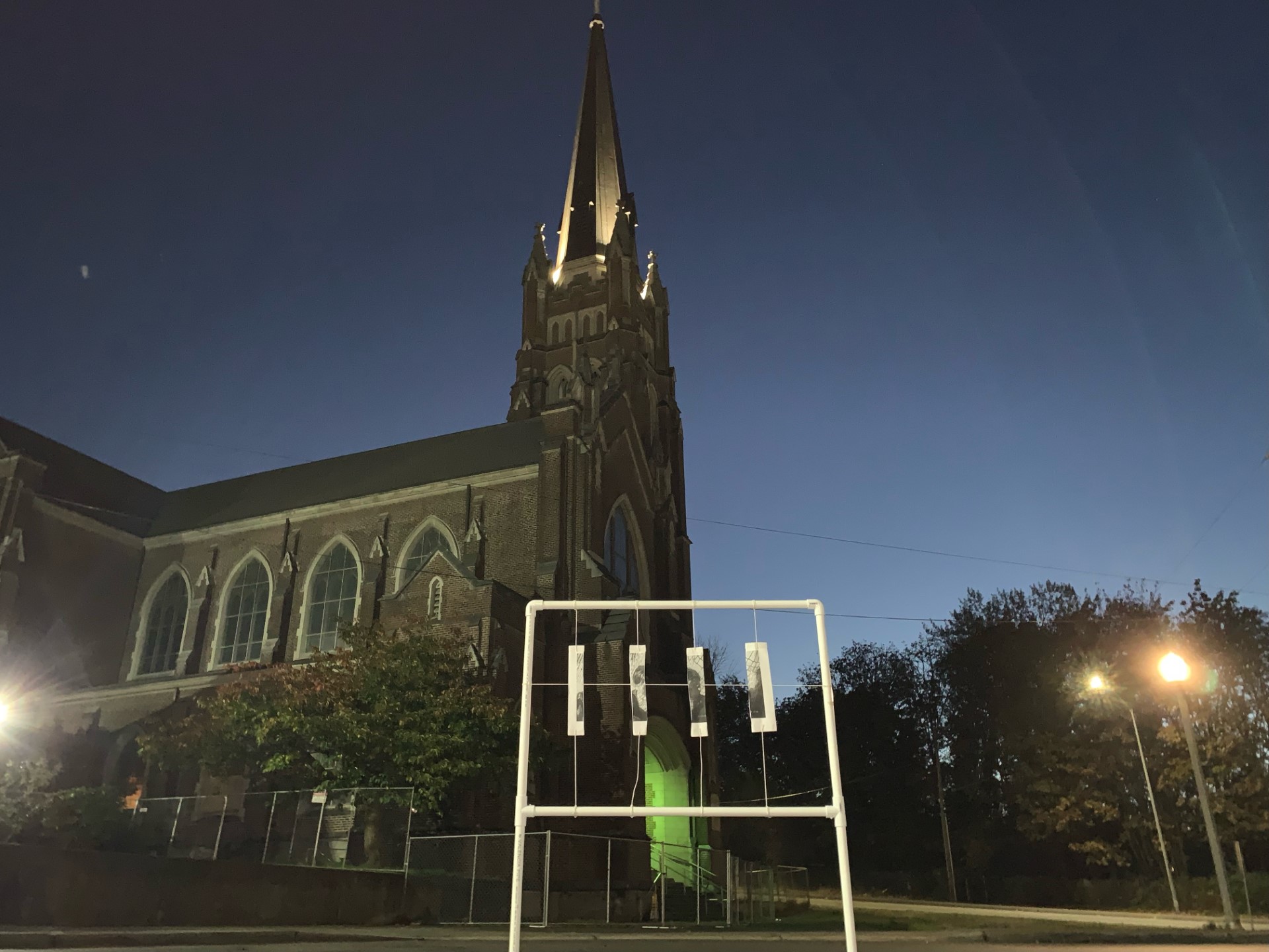 PICTURED: The exterior of an old church at twilight. A contemporary public art installation is in the foreground.