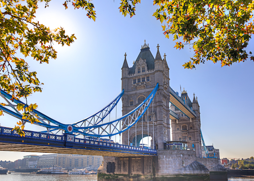 Image of London Bridge on sunny day with leaves surrounding border of image