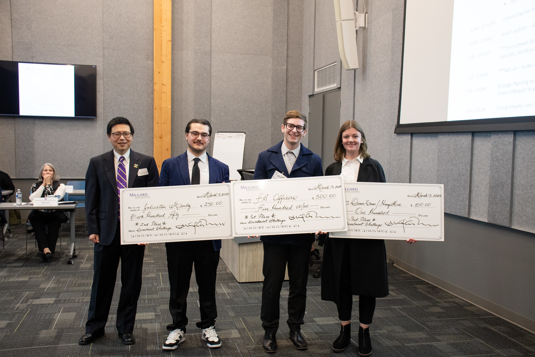 Investment Challenge Winners posing with their giant checks