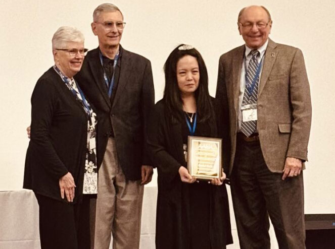 Rachel Endo receiving AAUA Award