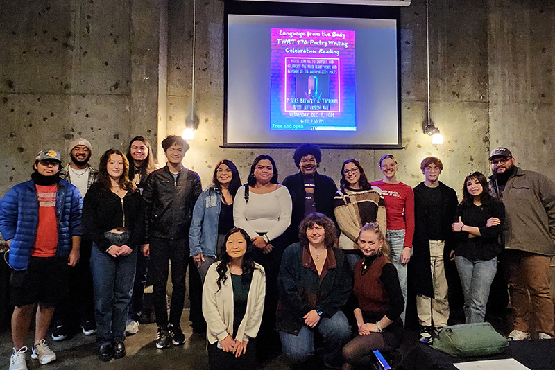 A photo of UW Tacoma students standing in front of a sign