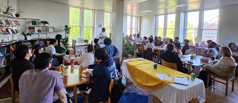 A photo of students watching a presenter talk