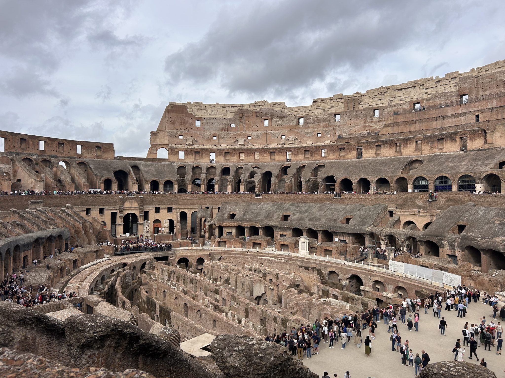 Roman Coliseum from afar with crowds.